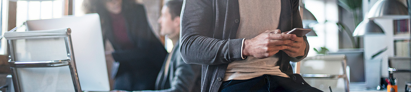 A guy in an office on a smartphone